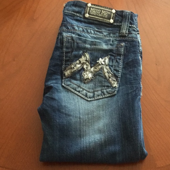 jeans with m on back pocket